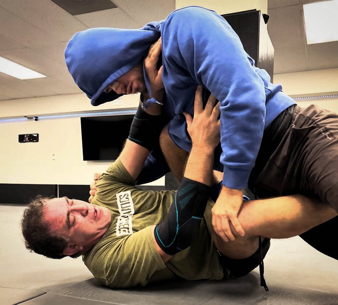 Coach Michael Zenga working a guard position on the mats.